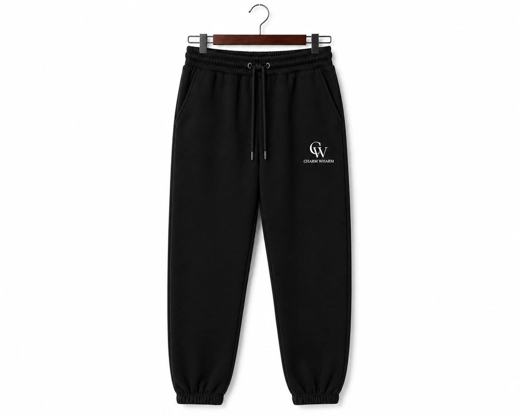 Black sweatpants with a drawstring waist and a small white 'CW' logo on the left thigh, hanging on a wooden hanger against a white background.