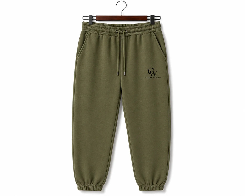 Olive green sweatpants with a drawstring waist and a small black embroidered logo on the left chest, hanging on a wooden hanger against a white background.
