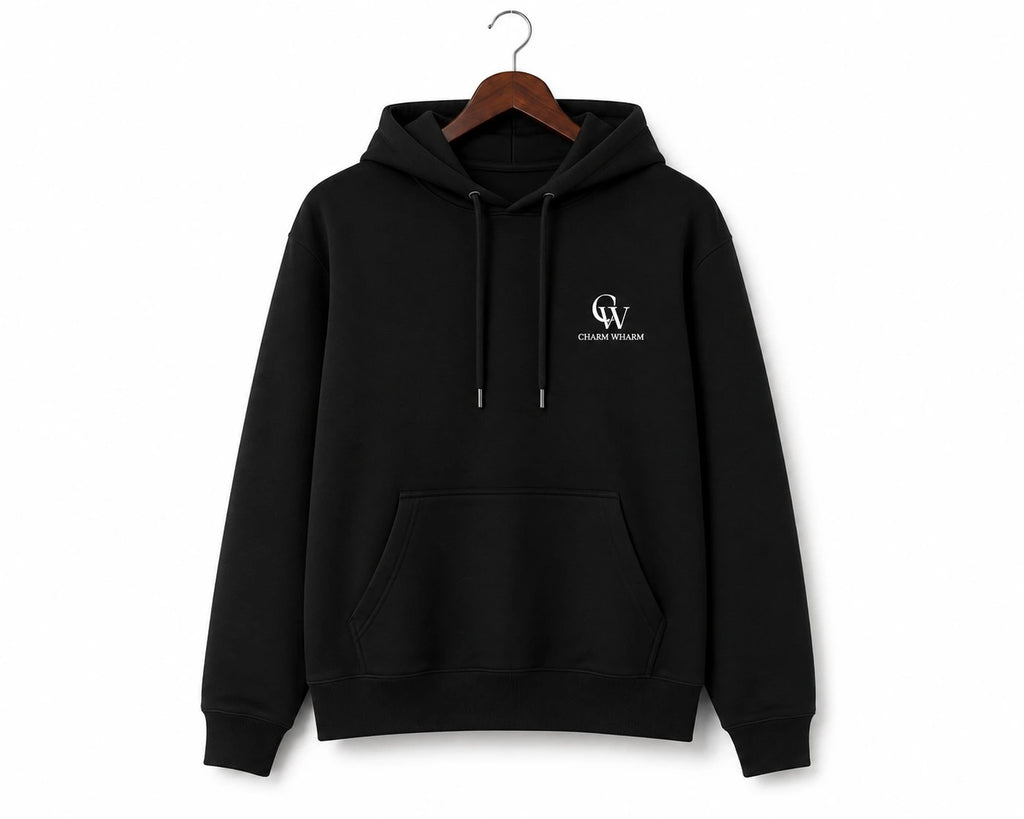 A black pullover hoodie with a small white 'CW' monogram and 'Charm Wharm' text on the left chest, hanging on a wooden hanger against a plain white background.