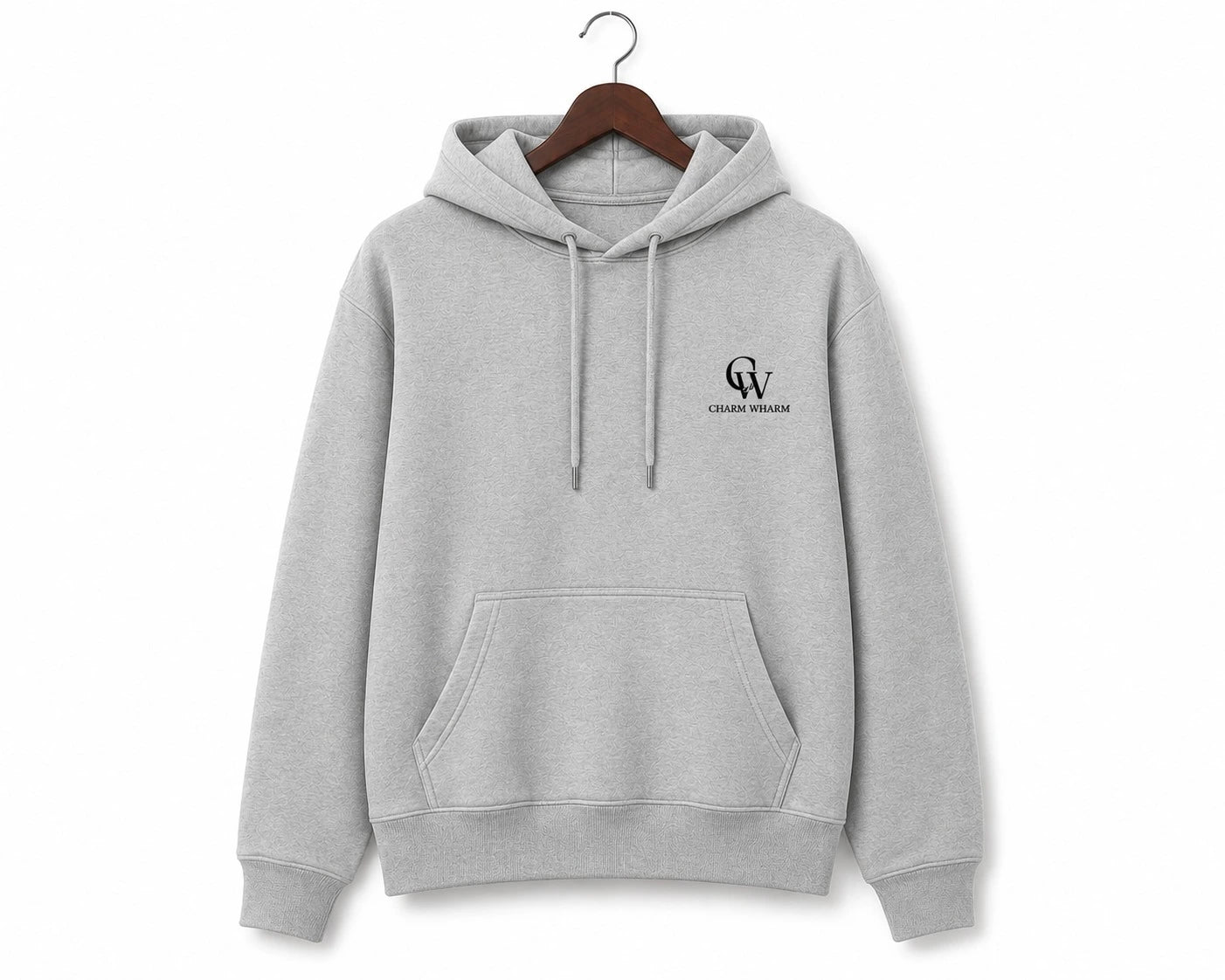 A light gray heather pullover hoodie hanging on a wooden hanger against a plain white background. The hoodie features a small black 'CW' monogram logo with 'Charm Wharm' printed below it on the left chest.